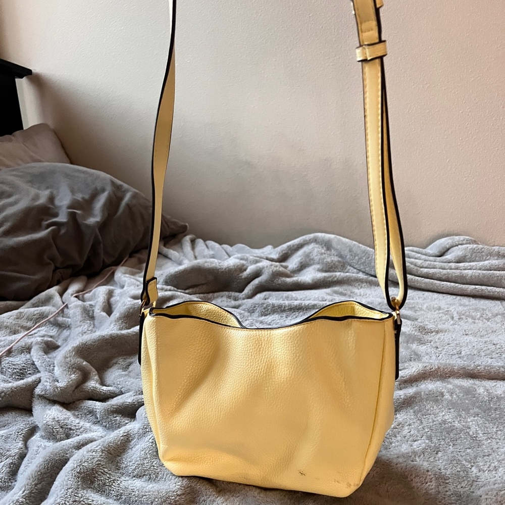 Yellow cross body purse. Well loved. A new day